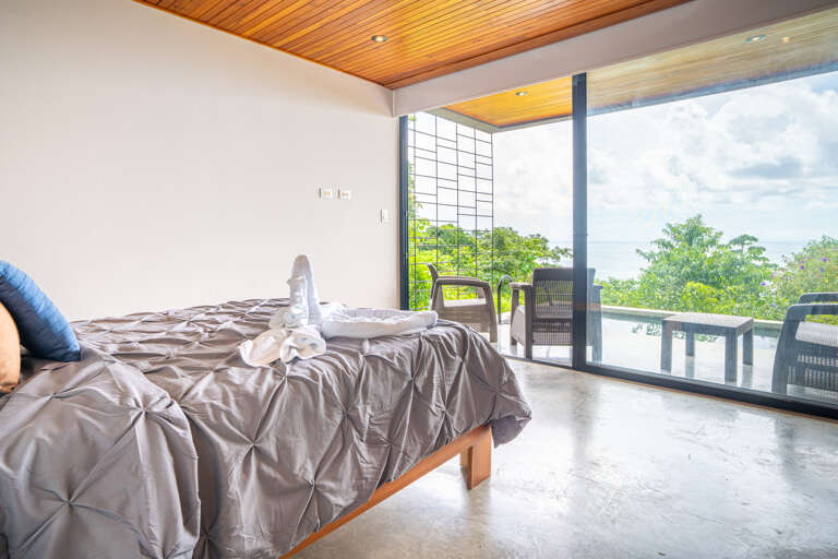 Bedroom With Bed And Balcony Overlooking Nature
