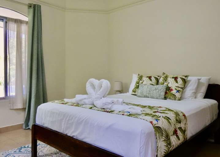 Interior Of A Bedroom With Made Bed And Decorative Pillows
