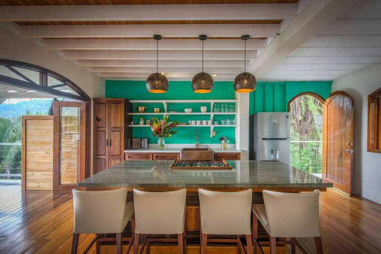 Verdant Green Kitchen, Wooden Beams, Brass Lamps, Bar Stools Facing Island