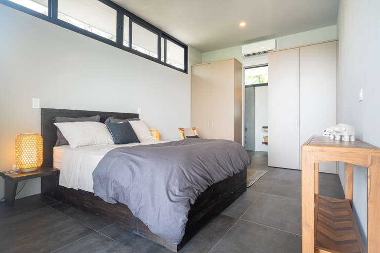 A spacious, modern bedroom with refined elegance, offering a peaceful and relaxing atmosphere. A spacious, modern bedroom with refined elegance, offering a peaceful and relaxing atmosphere.
