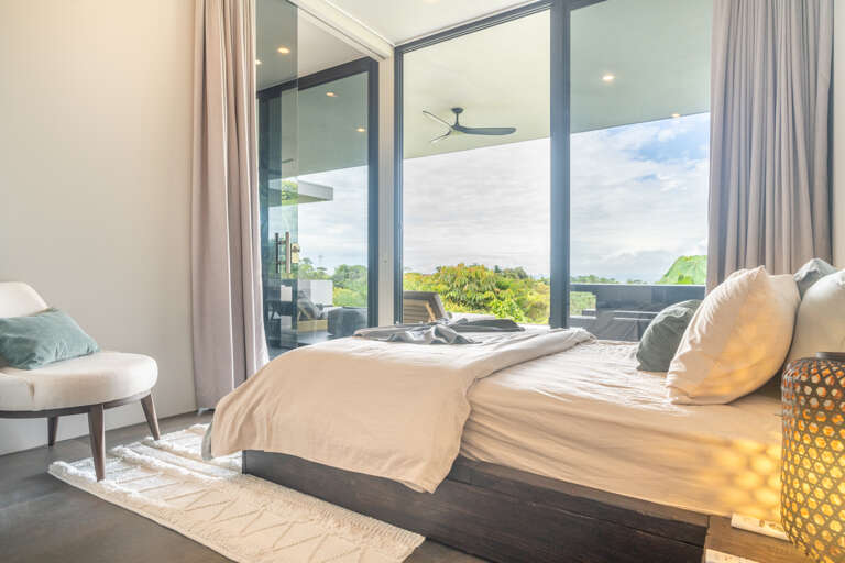 A stylish and airy room featuring large windows that frame stunning views of the pool and surrounding greenery. A stylish and airy room featuring large windows that frame stunning views of the pool and surrounding greenery.