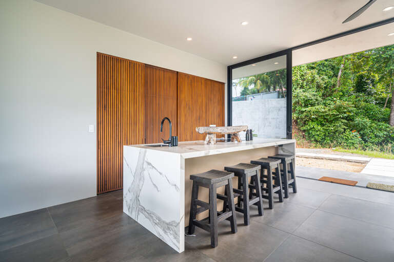 A bright, open concept kitchen with stunning views of both the pool and nature. A bright, open concept kitchen with stunning views of both the pool and nature.