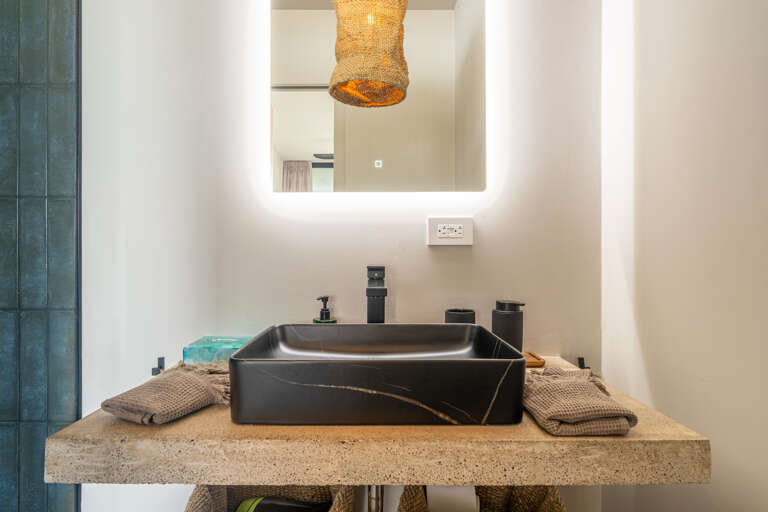 A modern, sophisticated bathroom with large glass windows, offering stunning views of the surrounding greenery. A modern, sophisticated bathroom with large glass windows, offering stunning views of the surrounding greenery.