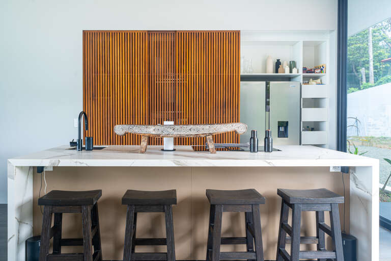 A contemporary kitchen with hidden sliding panels that discreetly conceal the kitchen from view, perfect for open-concept living A contemporary kitchen with hidden sliding panels that discreetly conceal the kitchen from view, perfect for open-concept living
