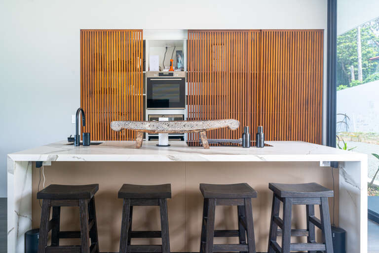 A sleek, modern kitchen with sliding doors that elegantly conceal the cooking area, creating a seamless living space. A sleek, modern kitchen with sliding doors that elegantly conceal the cooking area, creating a seamless living space.