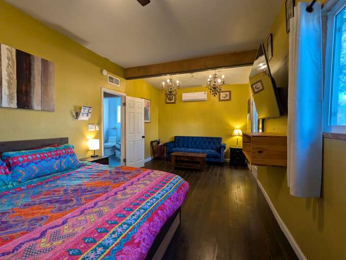 Bright bedroom with vibrant decor and lounge seating