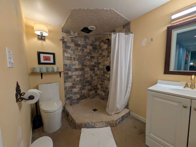 Stone-tiled corner shower