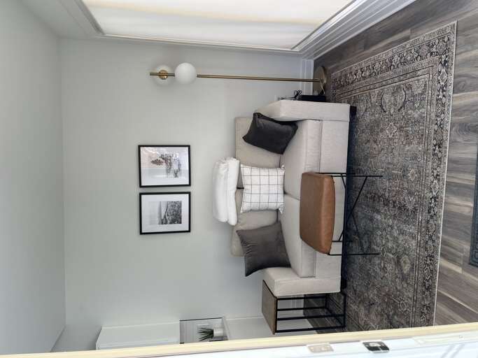 Living Room With Sofa, Table, Lamp, And Wall Art