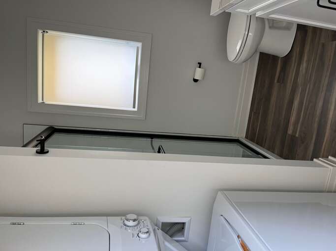 Interior Of A Bathroom With Shower, Toilet, And Washing Machine