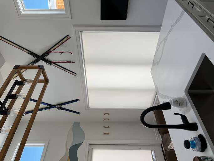 Modern Kitchen Interior With Hanging Ski Equipment