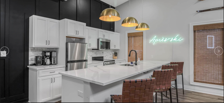 Modern Kitchen Interior With White Cabinets And Neon Sign