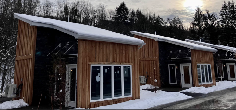 Modern Wooden Cabins In Snow-covered Setting