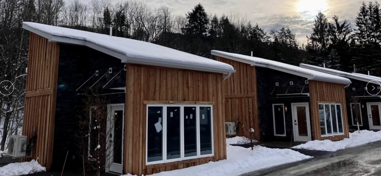 Wooden Lodges In Snow With Overcast Sky