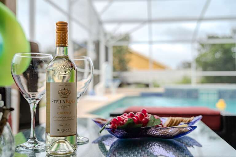 Seating by the pool (wine not included, for staging purposes only))