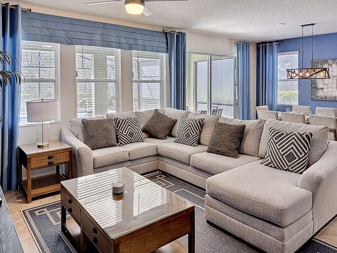 Spacious Seating, Sunlit Space, Plush Pillows, Patterned Pieces