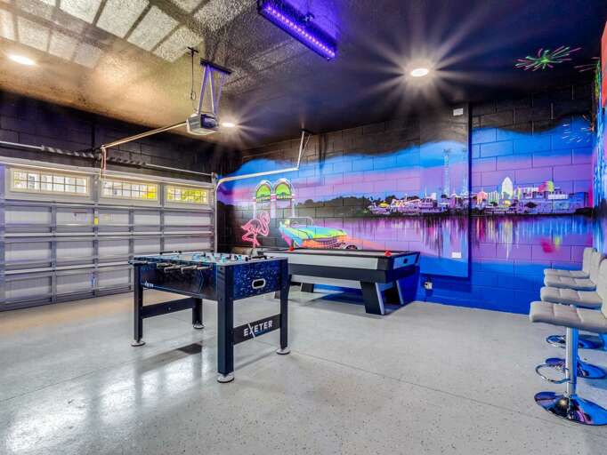 Game area with pool table, foosball, and arcades