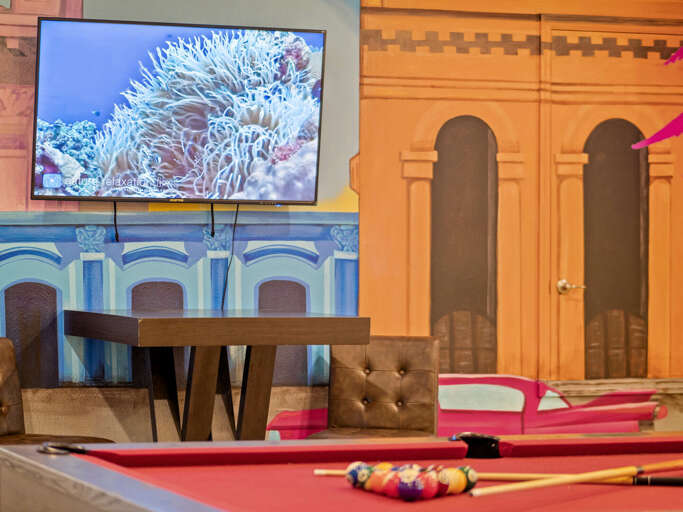 Little Havana themed game room with pool table and TV