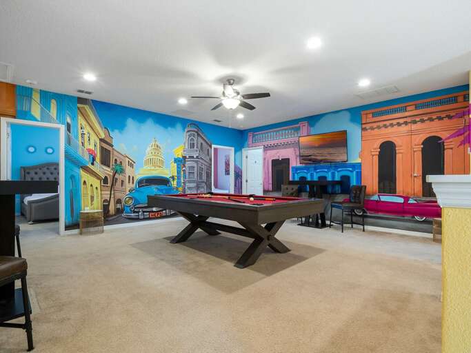 Little Havana themed game room with pool table and TV
