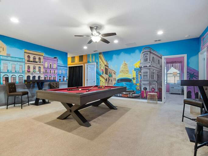 Little Havana themed game room with pool table and TV