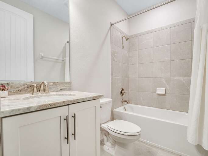 Bathroom with bathtub and shower combo