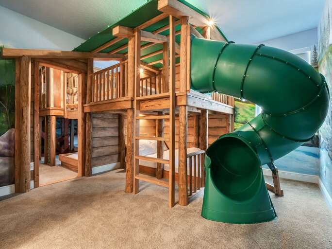 Tree lodge themed bedroom with Twin over Full bunk beds and fun slide