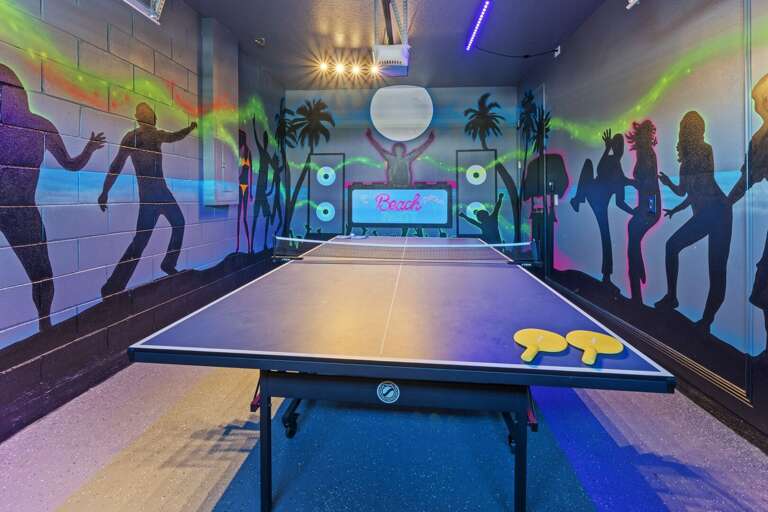Beach dance party themed game room with foosball and ping pong table