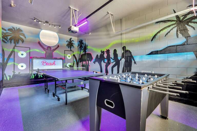 Beach dance party themed game room with foosball and ping pong table