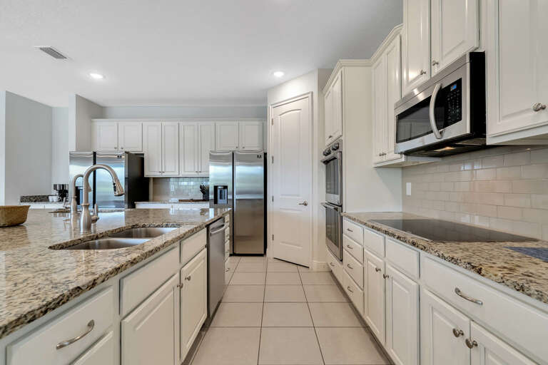 Kitchen area with spacious island and stainless-steel appliances
