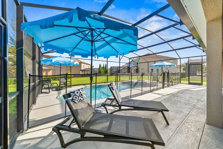 - Covered patio with lounge seating and outdoor dining tables  
- Relax with ceiling fans and poolside access in screened area  
- Orlando villa offering outdoor dining and family gathering