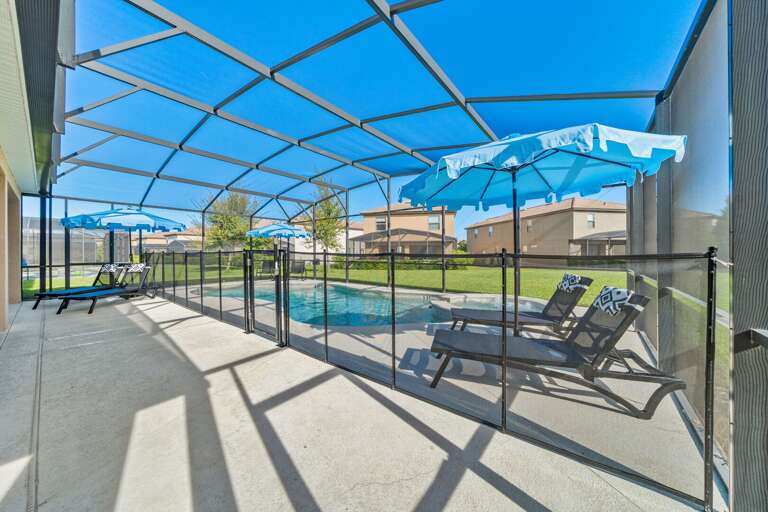 - Covered patio with lounge seating and outdoor dining tables  
- Relax with ceiling fans and poolside access in screened area  
- Orlando villa offering outdoor dining and family gathering