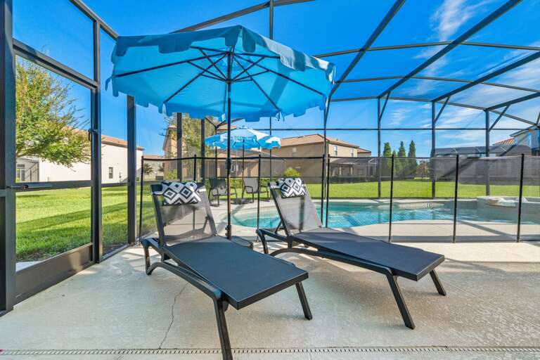 - Covered patio with lounge seating and outdoor dining tables  
- Relax with ceiling fans and poolside access in screened area  
- Orlando villa offering outdoor dining and family gathering