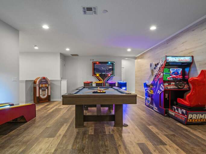 Game room with Skee-Ball, pool table, jukebox, and Pacman arcade