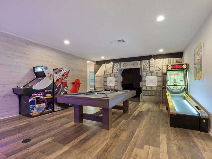 Game room with Skee-Ball, pool table, jukebox, and Pacman arcade
