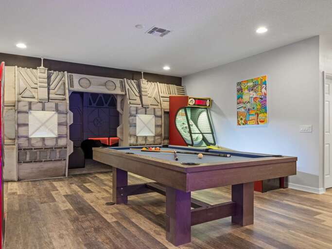 Game room with Skee-Ball, pool table, jukebox, and Pacman arcade