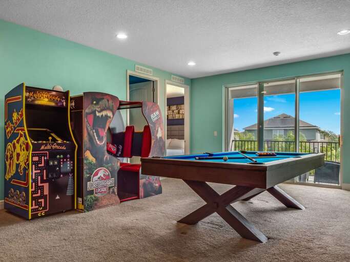 Game room with pool table, multiple arcades, and giant scrabble
