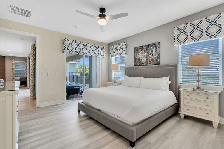 Bedroom with King bed and access to lanai and pool area Bedroom with King bed and access to lanai and pool area