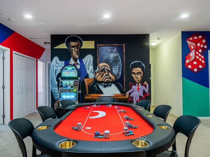 Vegas Lounge themed game room with poker table, slot machine and wet bar