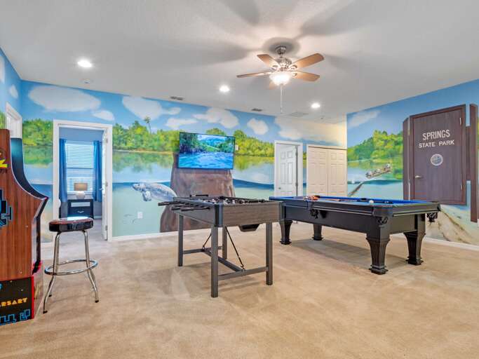 Manatee Springs themed game room with pool table, foosball, and arcade