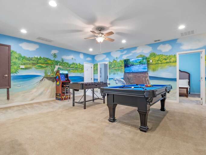 Manatee Springs themed game room with pool table, foosball, and arcade