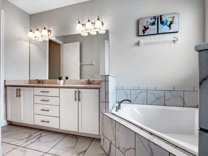 Bathroom with dual sinks, soaker tub, and glass enclosed shower Bathroom with dual sinks, soaker tub, and glass enclosed shower