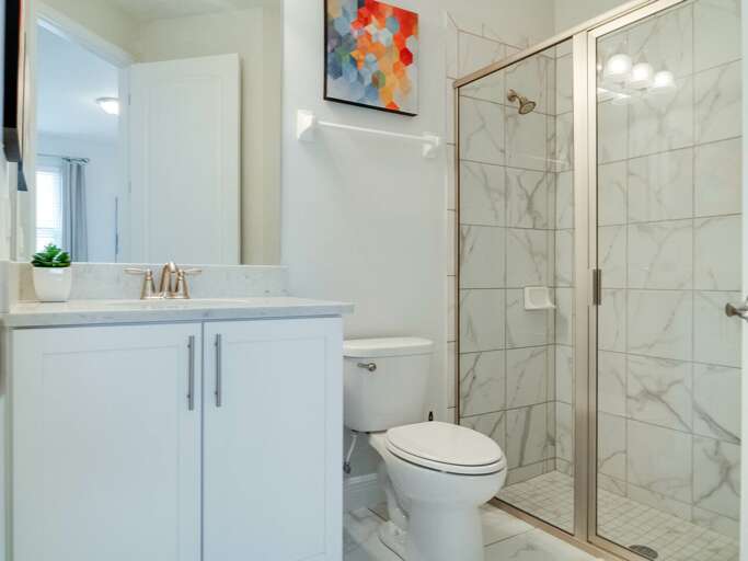 Bathroom with glass enclosed shower Bathroom with glass enclosed shower