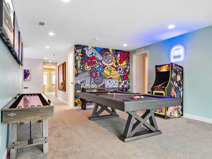 Game room with pool table, shuffleboard, giant scrabble, and arcade Game room with pool table, shuffleboard, giant scrabble, and arcade