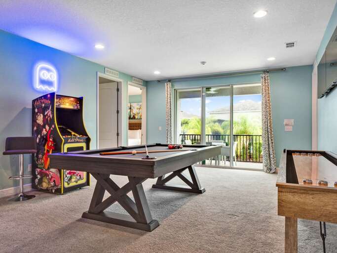 Game room with pool table, shuffleboard, giant scrabble, and arcade Game room with pool table, shuffleboard, giant scrabble, and arcade