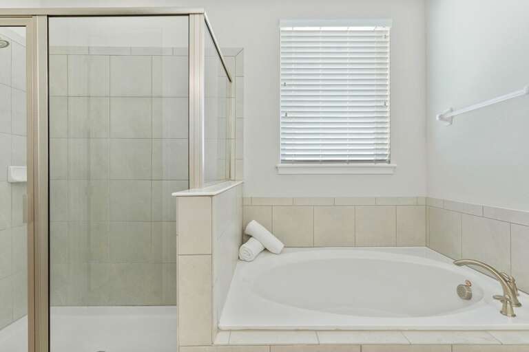 Bathroom with jetted tub and glass enclosed shower