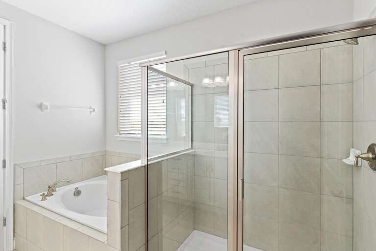 Bathroom with jetted tub and glass enclosed shower