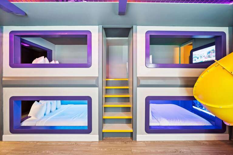 Hero's and Villains bedroom w/ personal TVs and slide