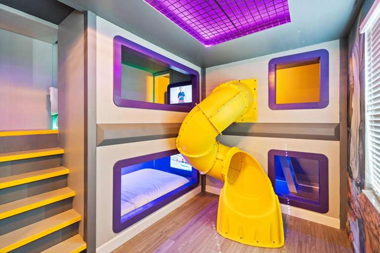 Hero's and Villains bedroom w/ personal TVs and slide