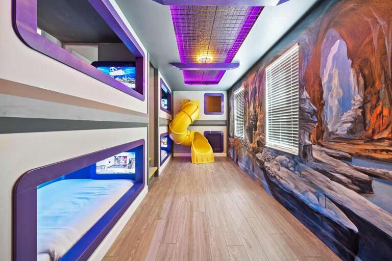Hero's and Villains bedroom w/ personal TVs and slide