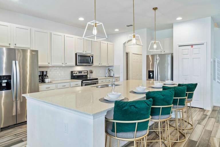 Kitchen area with spacious island and stainless steel appliances