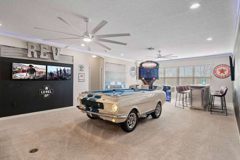 Game room with Mustang pool table, arcade, and wet bar